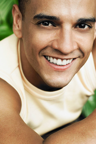 close-up of a young man smiling - Фото, изображение