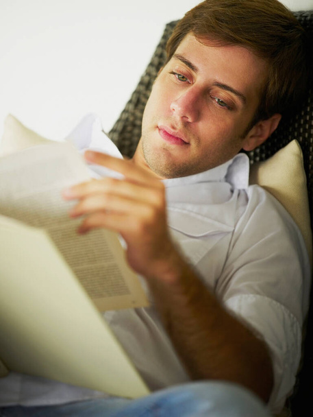 young man lying on sofa and using laptop - Foto, Imagem