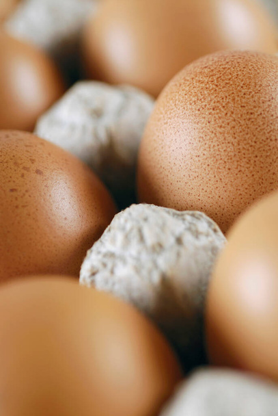 eggs in a cardboard box on a white background - Фото, зображення
