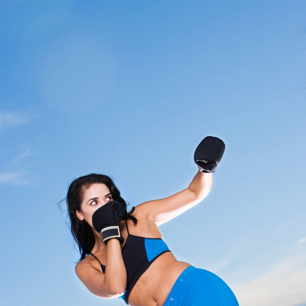 Low angle view of a mid adult woman punching - Foto, imagen