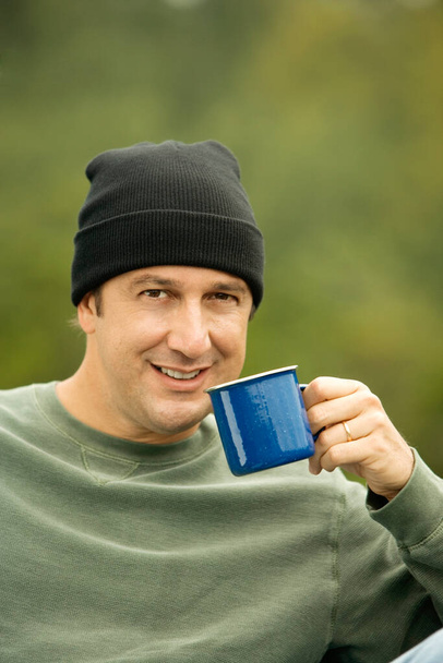 man with cup of coffee and mobile phone outdoors - Fotografie, Obrázek