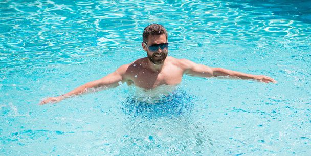 cheerful man in swimming pool. Pool party. Summer mood concept. Summertime vacation. - Photo, Image