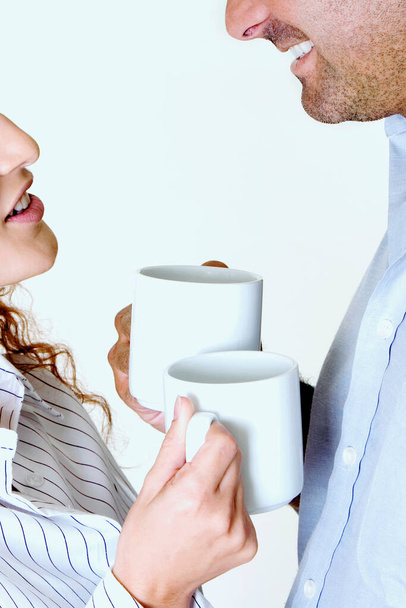 Detailní záběr mladý pár drží šálky kávy a usmívá - Fotografie, Obrázek