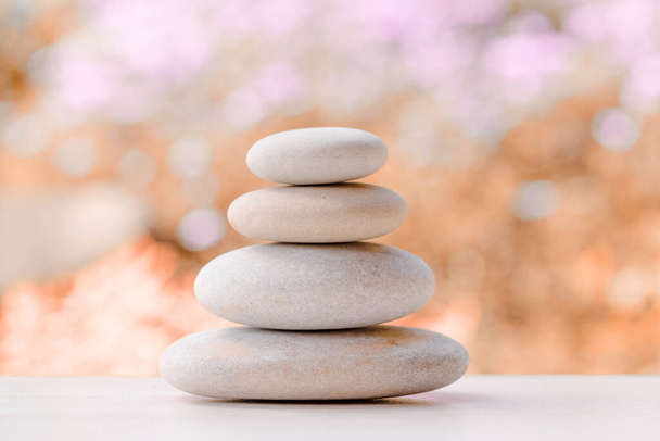 balancing pile of pebble stones, like ZEN stone, outdoor in springtime, spa wellness tranquil scene concept, soul equanimity mental calmness picture - Foto, Imagem