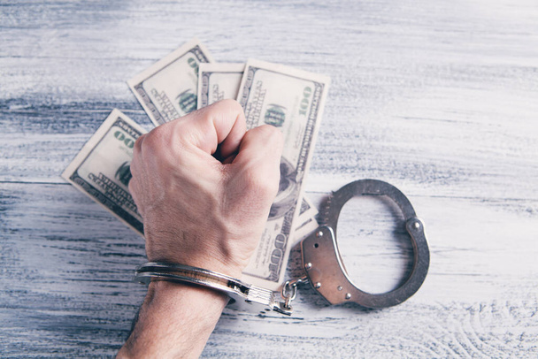handcuffed at the table with money - Photo, Image