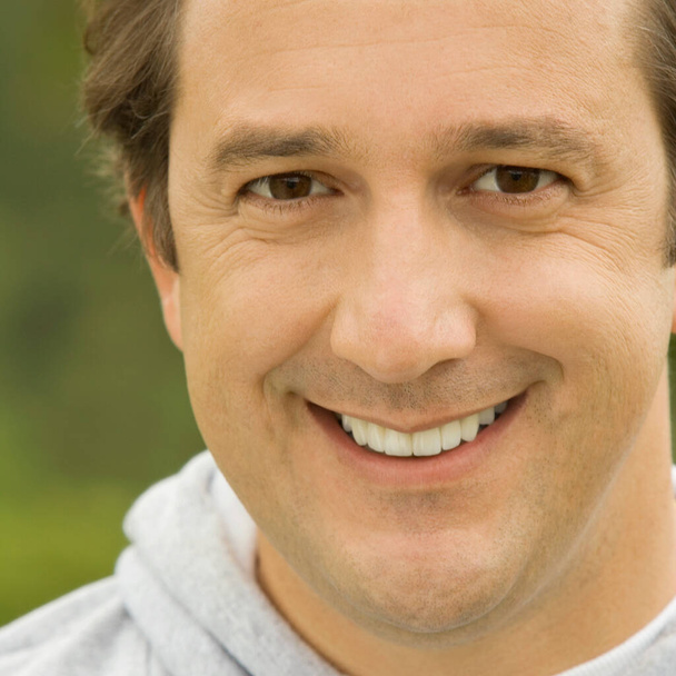 close-up of a mature man smiling - Foto, afbeelding