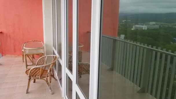 4k videó, fonott bútorok egy modern hotel erkélyén panorámás ablakokkal - Felvétel, videó