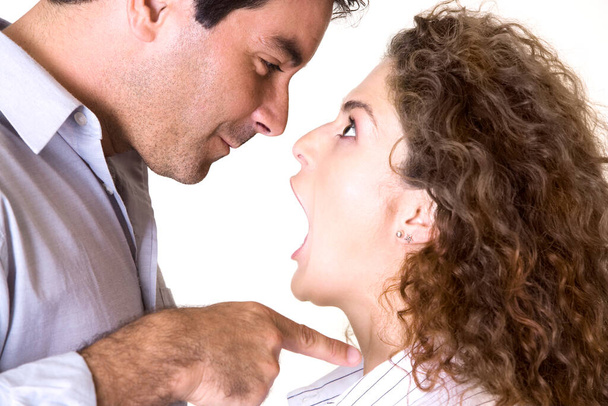Side profile of a mid adult man and a young woman arguing - Foto, Bild