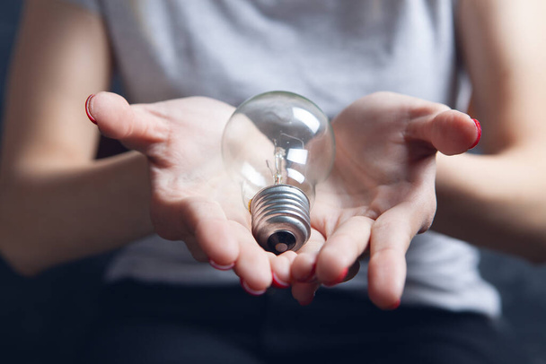 young girl holding a light bulb - Zdjęcie, obraz