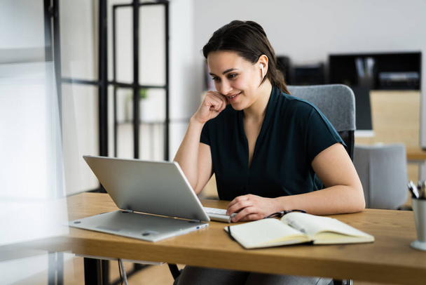 young woman working with laptop in office - Foto, Bild