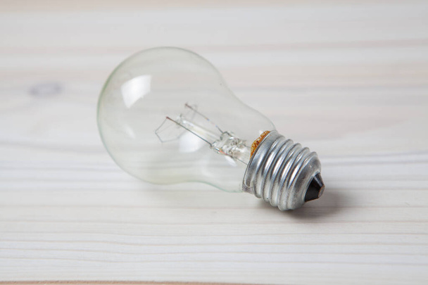 light bulb on a wooden table - 写真・画像