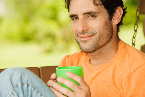 Portrait of a mid adult man holding a coffee cup - Фото, изображение