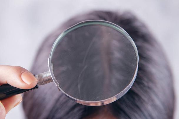 magnifying glass looking at hair - Фото, изображение