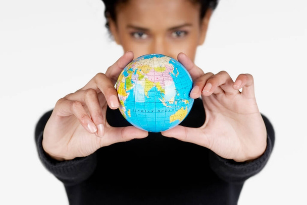 young woman holding a globe - Фото, изображение