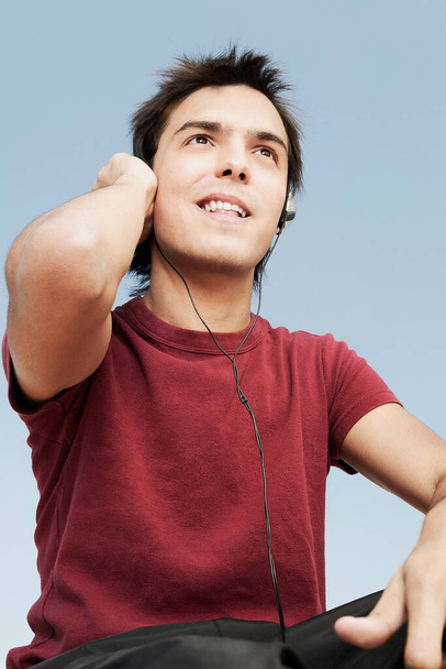 young man listening to music on headphones - Fotoğraf, Görsel