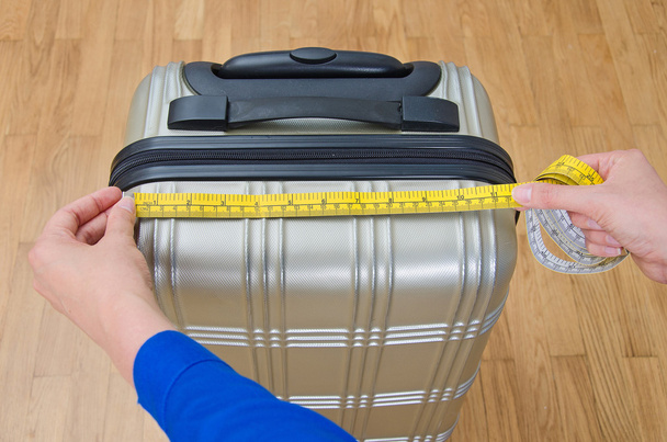 Hand luggage measurement using measuring tape. - Valokuva, kuva