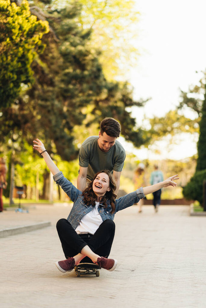 Young Couple practicing skateboarding outdoors - Foto, Imagem