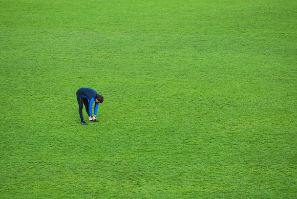 young woman doing yoga exercises on green grass - Fotoğraf, Görsel