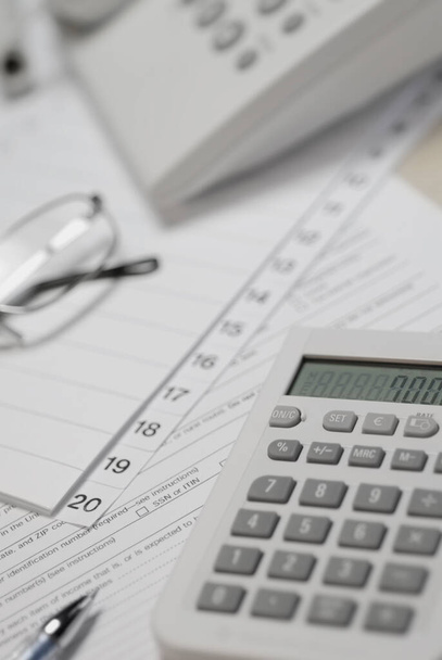 financial report with calculator and pen - Фото, изображение