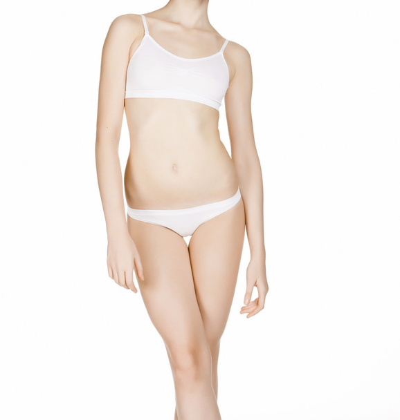 Kaunis ohut naisrunko alusvaatteissa, eristetty valkoisella selkäkilolla
 - Valokuva, kuva