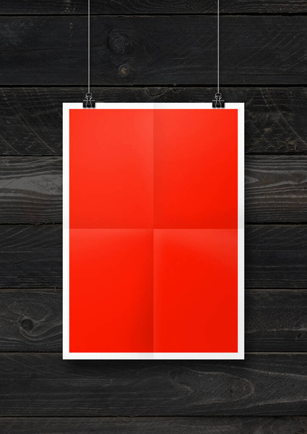 Red folded poster hanging on a black wooden wall with clips. Blank mockup template - Foto, imagen