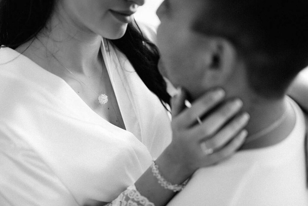 the bride and groom tenderly hold hands between them love and relationships - 写真・画像
