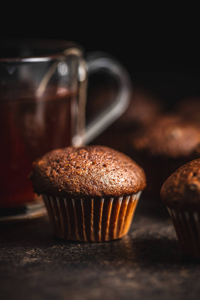 Chocolate muffins. Sweet dark cupcakes on black table. - Valokuva, kuva