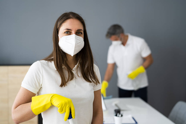 Cleaning Service Janitor Near Desk In Covid Face Mask - 写真・画像