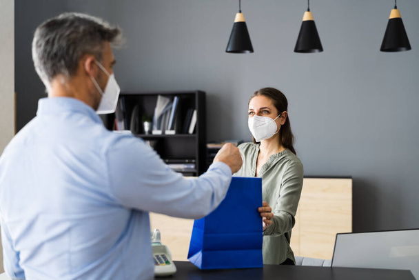 Cashier In Retail Shop Or Store At Counter Wearing Face Mask - Foto, Bild