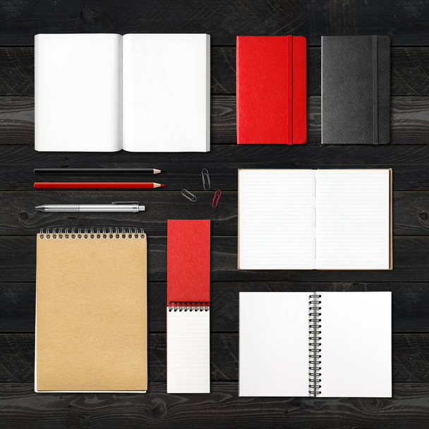stationery books and notebooks mockup template isolated on black wood background - Foto, afbeelding