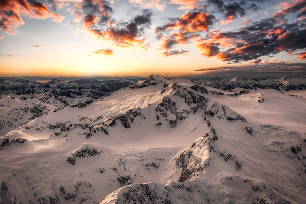 Aerial view from above of White Glacier Mountains. Canadian Nature Background. Located near Squamish and Vancouver, British Columbia, Canada. Sunset Sky - Foto, afbeelding