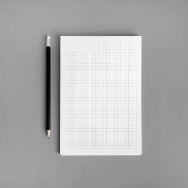 Blank copybook and pencil on gray paper background. Branding ID template. Flat lay. - Valokuva, kuva