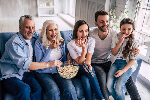 La famiglia felice multi generazione che guarda una TV - Foto, immagini