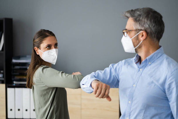 Employee Social Distancing Elbow Bump Wearing Covid Face Mask - 写真・画像