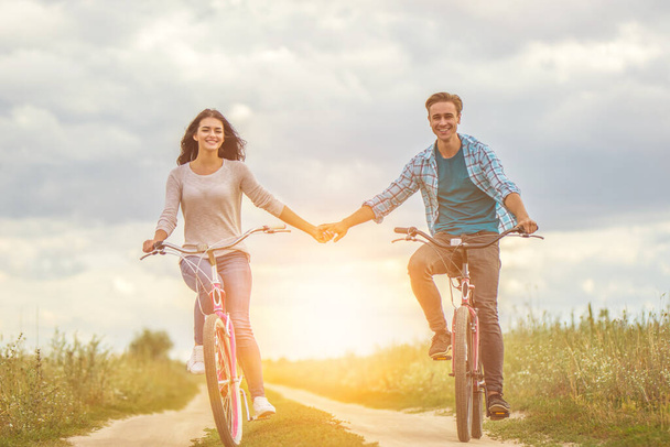 The happy man and woman cycling outdoor - Photo, Image