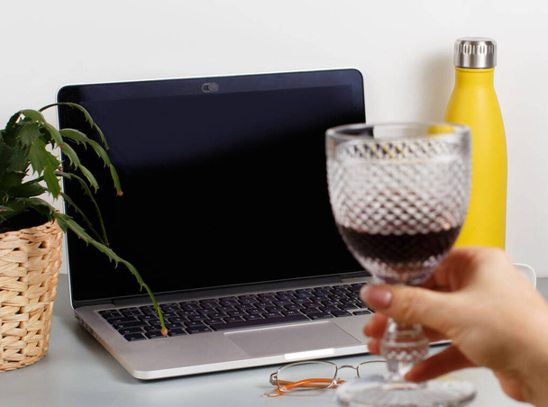 Two friends drinking wine while having a video call close up. Laptop mockup - Valokuva, kuva