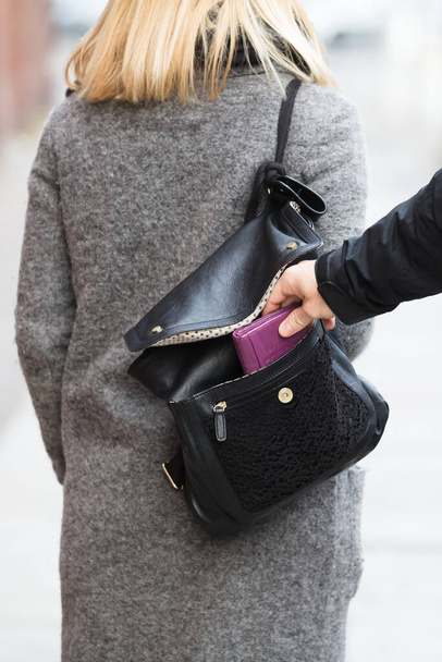 Close-up Of A Person Stealing Purse From Handbag - Фото, изображение