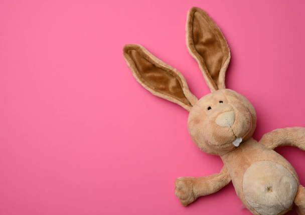 cute plush bunny with long ears, easter pink background, copy space - Foto, Imagen