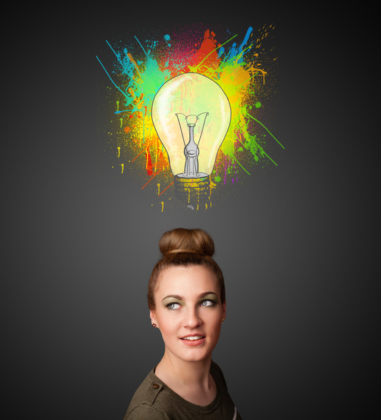 Young woman thinking with lightbulb above her head - Photo, Image