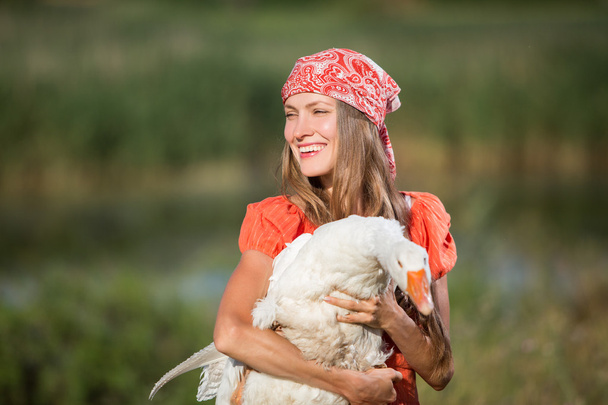 Beautiful girl holding goose - Foto, imagen