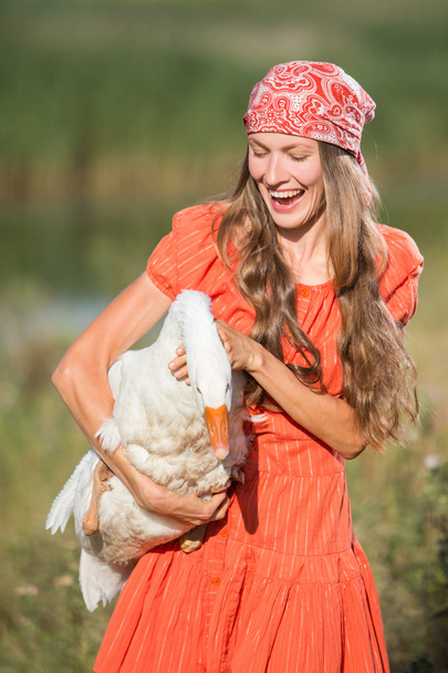 Funny portrait of woman with a goose - Valokuva, kuva