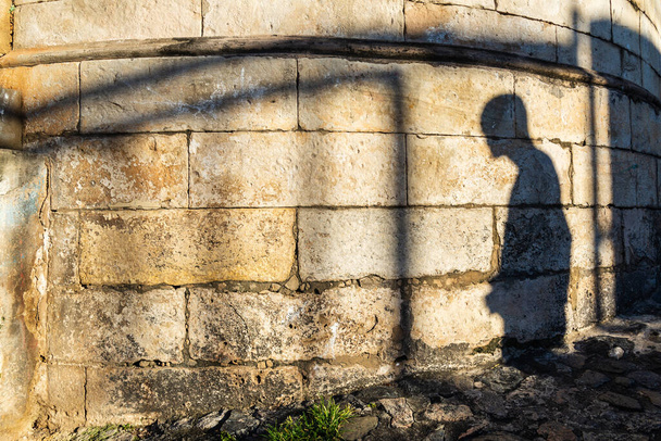 Salvador, Bahia, Brazil - July 18, 2021: Silhouette of the shadows of people on the stone wall in Pelourinho. - Fotografie, Obrázek