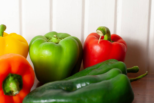 Yellow, green, red, and orange bell peppers with a pair of poblano peppers - Foto, immagini