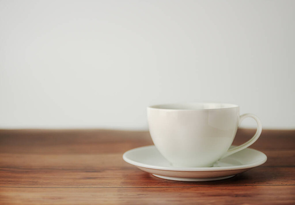 A cup of coffee on wooden blurred white background - Zdjęcie, obraz
