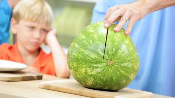 Father slicing watermelon for children - Footage, Video