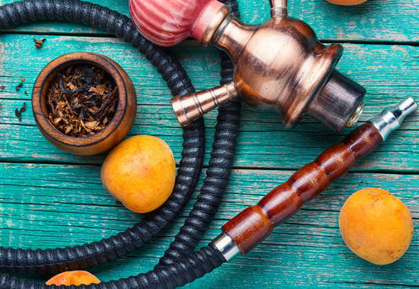 East shisha.Hookah tobacco with taste of ripe apricots.Smoking oriental hookah - Foto, immagini