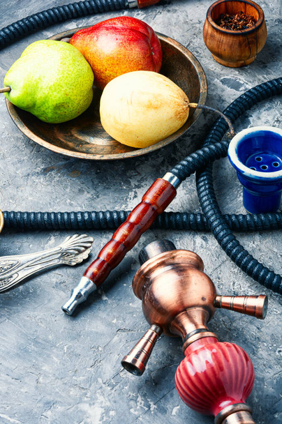 Details of the eastern kalian.Hookah with pear flavor.Smoking pear tobacco - Foto, immagini