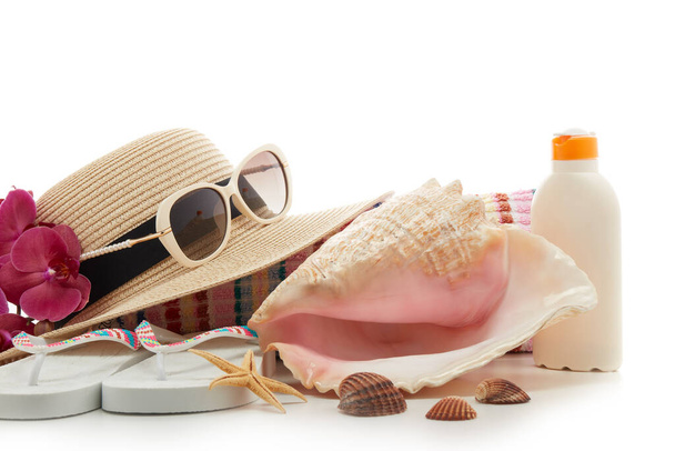 Beach accessories: flip flops, straw hat, sunglasses, sunscreen isolated on white background. Concept of sea vacation and travel. Summer background, Protection from uv - Foto, imagen