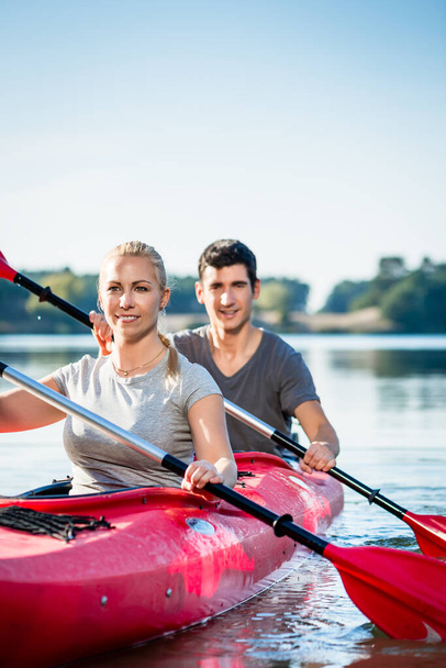 young couple kayaking in river - Photo, image