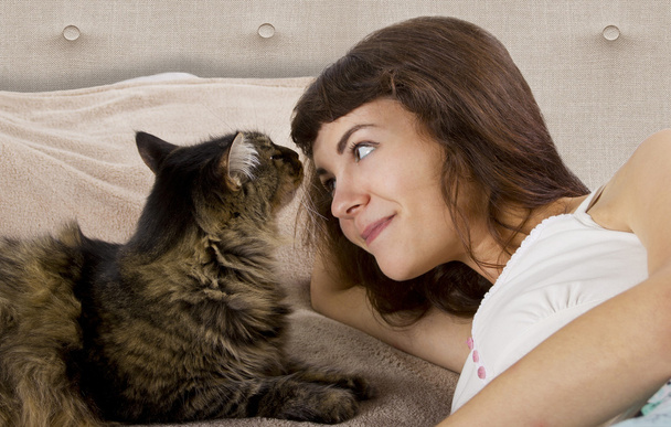 Cat is on a teenage girl's bed - Foto, Bild